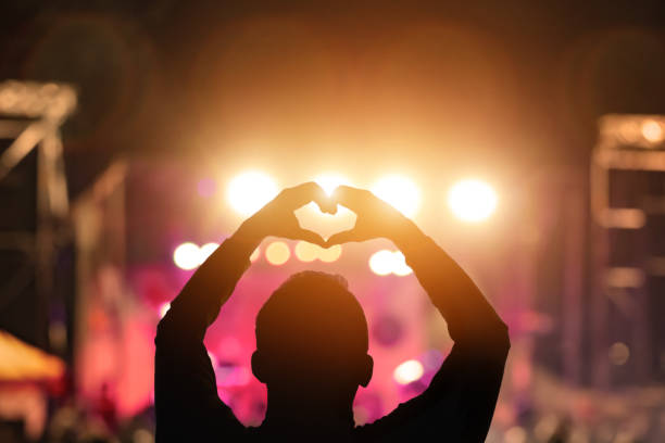 istock Silhouette of a man with concert stage lights 1465028414
