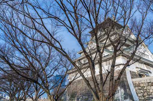 Osaka, Japan - 03 February, 2023. A winter day shot outside Osaka Castle in Osaka, Japan. This area attracts thousands of locals and tourists every year and offers some amazing walks and scenery, Tourists flock here to experience of Japanese cultural tourism.