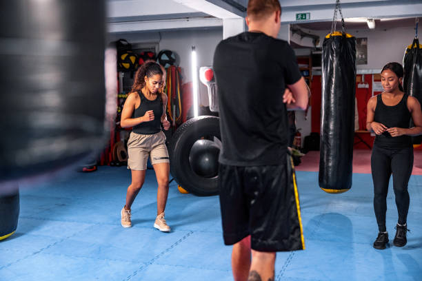 istock Fit Young Multiracial People Training With A Boxing Coach 1465033454