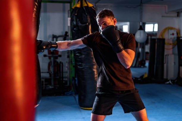 istock Handsome Young Male Boxer Training Alone With Boxing Gloves 1465033558