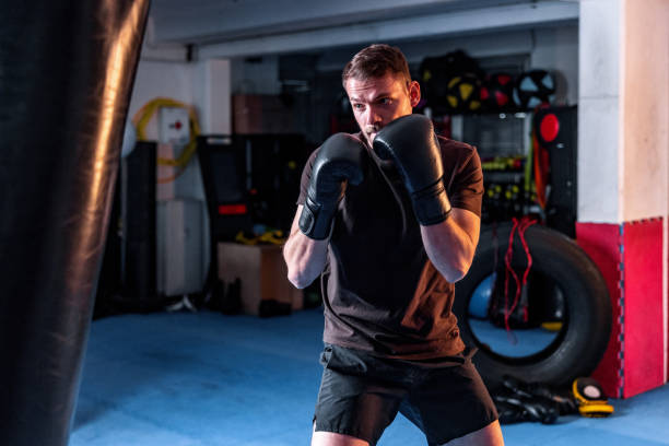 istock Handsome Young Male Boxer Training Alone With Boxing Gloves 1465033559