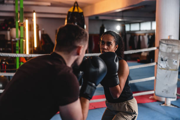istock Diverse Male And Female Boxers Practicing In A Boxing Ring 1465033668