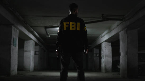 istock An FBI agent from the back  in a dark garage 1465033770