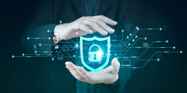 Protection network security computer in the hands of a businessman on a blue background. Shield Internet protected from hacker attacks, privacy network, antivirus software, screen guard safety system.