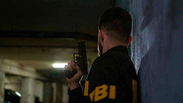 istock Armed FBI agent on a mission in a dark underground parking 1465038119