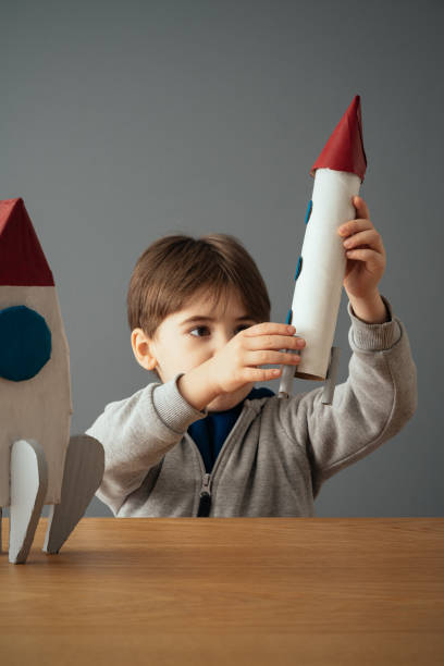 istock Little boy plays and fun with space rocket 1465039510