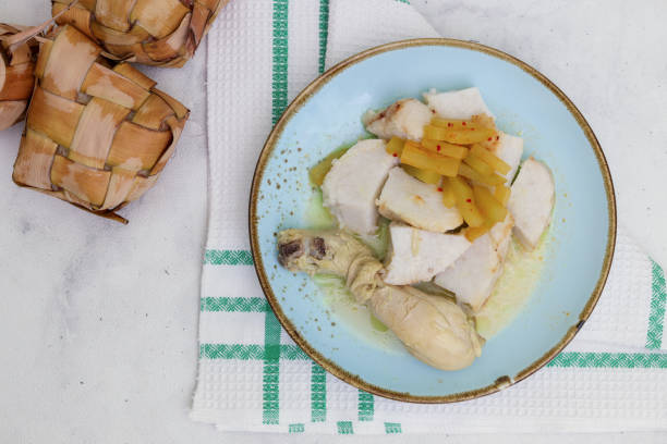 istock Ketupat or rice dumpling and chicken soup known as opor ayam on white background 1465046372