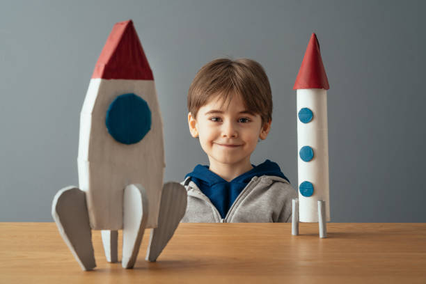 istock Portrait of little boy with space ship and rocket 1465047535