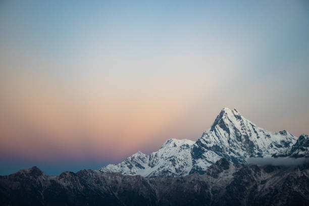 Colorful Himalayan Mountain Photo of Macchapucchre Mountain with sun rising in the background mount everest stock pictures, royalty-free photos & images