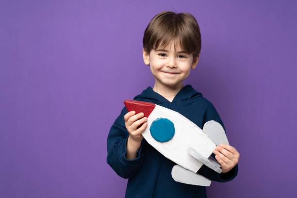 istock Little boy plays and fun with space rocket 1465049851