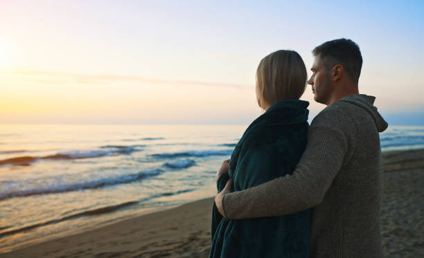 istock Couple at sunset by the sea. 1465050331