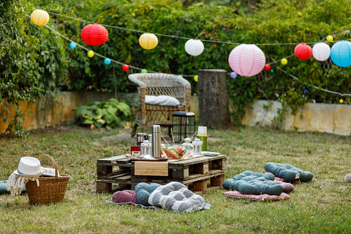 Garden party setting in a backyard is filled with lush greens, colorful blooms, and the sweet scent of summer, creating a truly immersive and unforgettable experience for everyone in attendance.