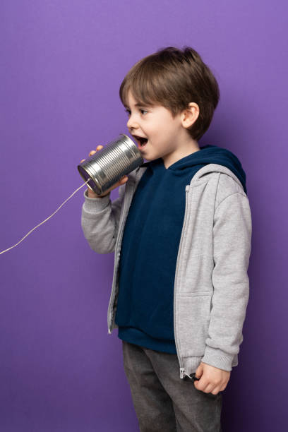 istock Little boy using a tin can as telephone 1465056730