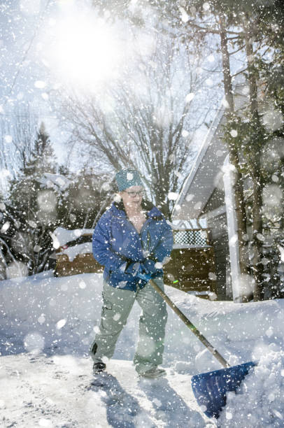 istock Mature woman pushing snow with shovel 1465061687