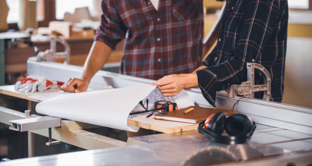 istock Couple of young carpenter working together 1465064516