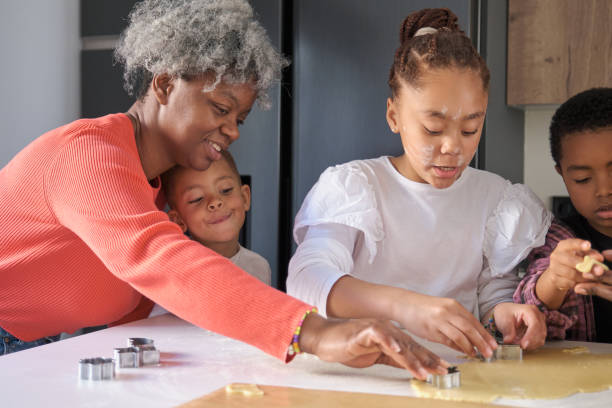 istock African family cutting cookie shapes in a cookie dough in the kitchen. 1465064607