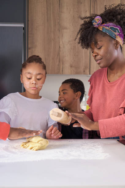 istock African family kneading cookie dough in the kitchen. 1465064732