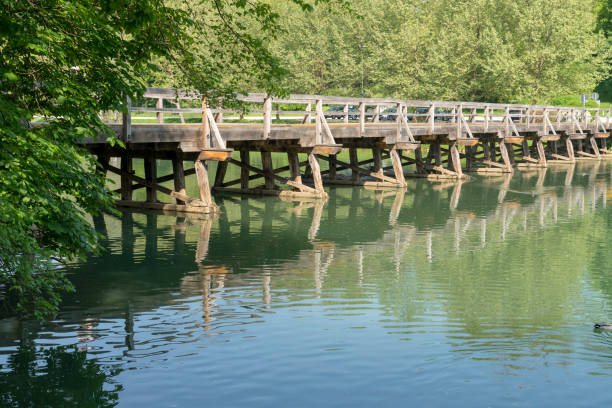 Long wooden bridge over the river Krka, forest in background.