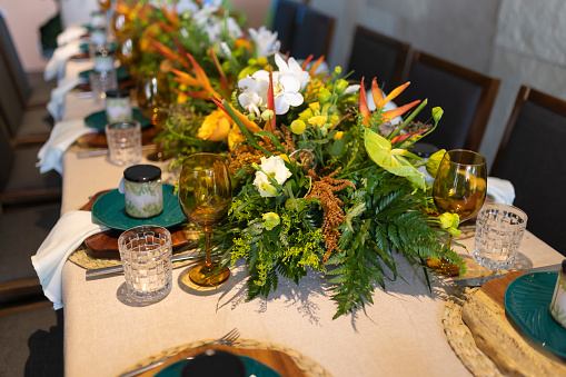 A beautifully served table at the festival is decorated with natural wood and fresh greenery.