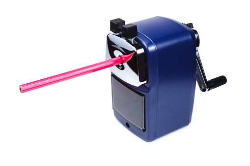 Rotary pencil sharpener with rose colored pencil on white background.