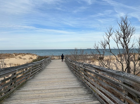 A wooden pathway leading down to a sandy beach