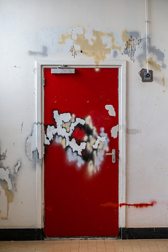 The Hague, Netherlands A red door in an art studio is damaged by paint and chemicals.