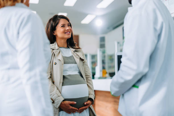Cheerful pregnant woman in drugstore. stock photo