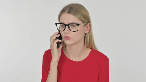 young woman talking angry on phone on white background - 11315 imagens e fotografias de stock