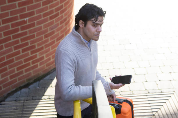 istock A professional man waiting with a mobile phone 1465102455
