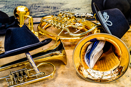 Woman's hands playing a horn or French horn, in the orchestra.