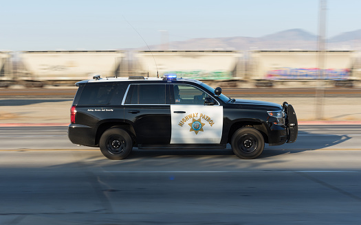 Mojave, California, USA: California Highway Patrol vehicle shown speeding down California State Route 14 in Kern County.