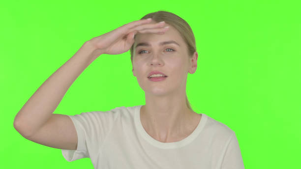 Casual Young Woman Looking Around, Searching Green Screen