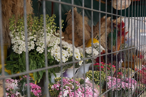 bouquets of flowers behind bars