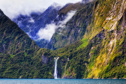 Glacier Waterfall in Milford sound mountain fiord on New Zealand south island from a cruise boat.