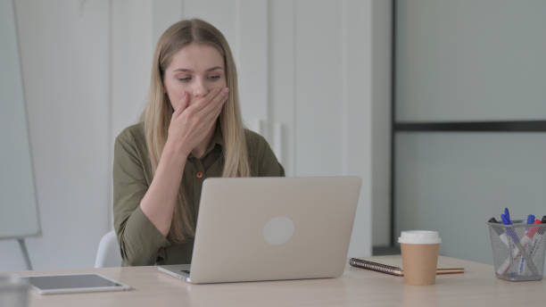 istock Young Blonde Woman Reacting to Loss While using Laptop 1465115229