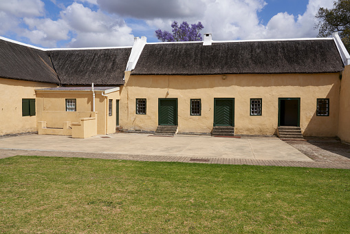 Swellendam, South Africa - 18 November 2022: Historic buildings in the Cape Dutch style of architecture that form the Drostdy Museum in Swellendam, Western Cape, South Africa