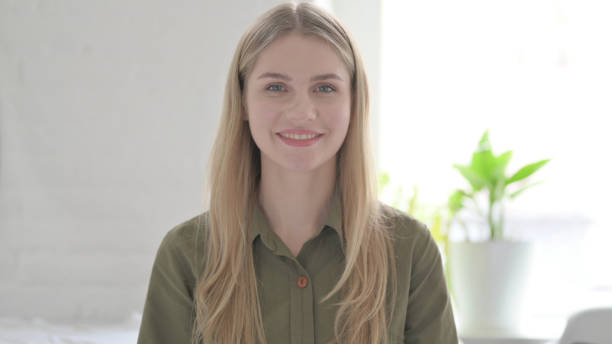 istock Young Blonde Woman Smiling at Camera 1465119534