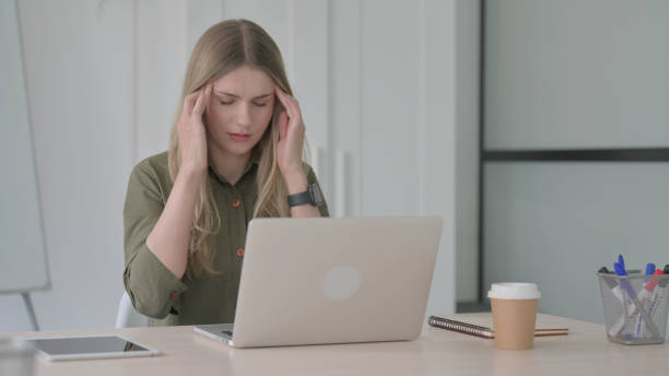 istock Young Blonde Woman having Headache while Working on Laptop 1465120977