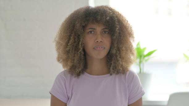 istock Young African Woman Shaking Head as No Sign 1465121134