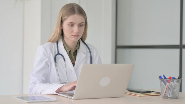 istock Lady Doctor Working on Laptop in Clinic 1465123222