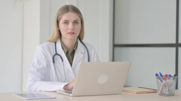 istock Lady Doctor Looking at Camera at Work in Clinic 1465123302