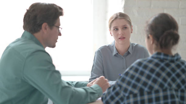 istock Young Blonde Woman Talking During Meeting 1465124918