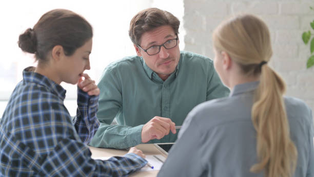 istock Angry Man Talking  with Female Teammate During Meeting 1465126534