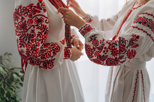 Ukrainian woman in embroidery and coral beads. Girls in Ukrainian embroidered shirts wear corals. Ukrainian traditional embroidered dress