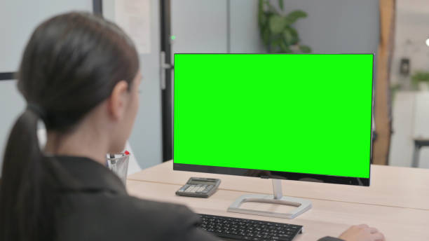 istock Young Businesswoman Working on Computer with Green Screen 1465129674