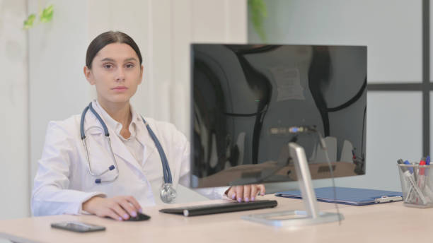 istock Young Female Doctor Looking at Camera at Work in Clinic 1465132625