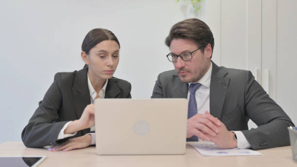 istock Business Colleagues Talking about Work on Laptop 1465132999