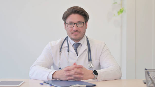 istock Serious Middle Aged Doctor Looking at the Camera 1465134075