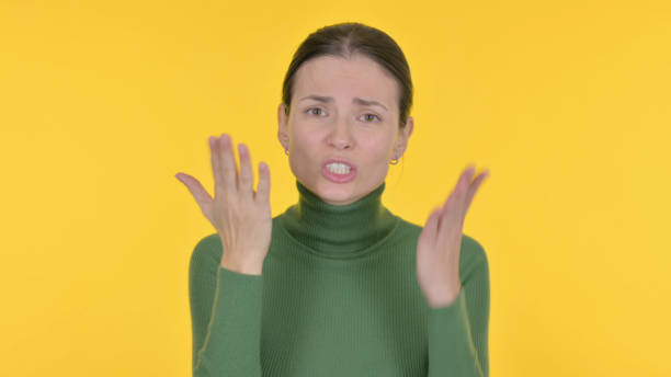 istock Angry Beautiful Woman Arguing on Yellow Background 1465134560