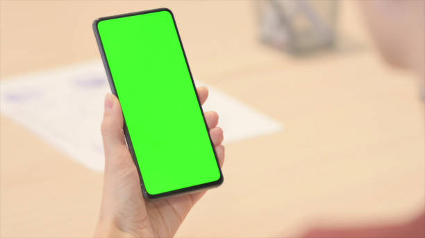 istock Close up of Female Hand Using Smartphone with Chroma Key 1465136680